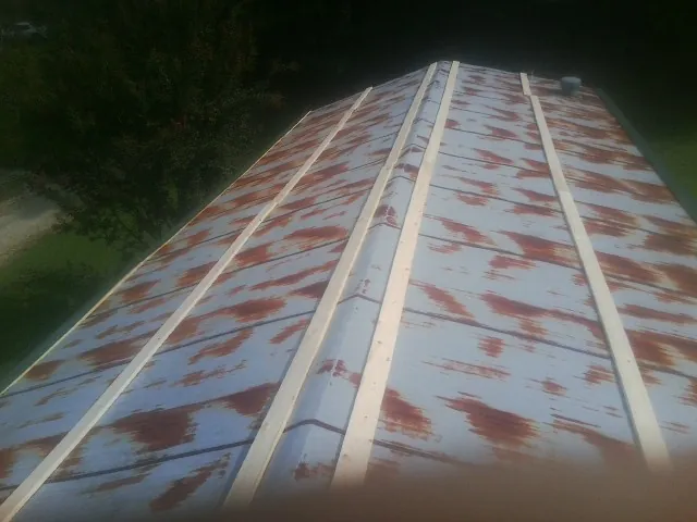 Rusted metal roof panels with new wood purlins before replacement — Storm Damage Roof Repair in Lone Wolf by Roofing Brothers
